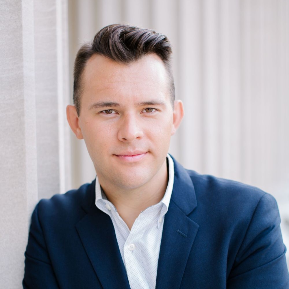 Man in white shirt and blue blazer